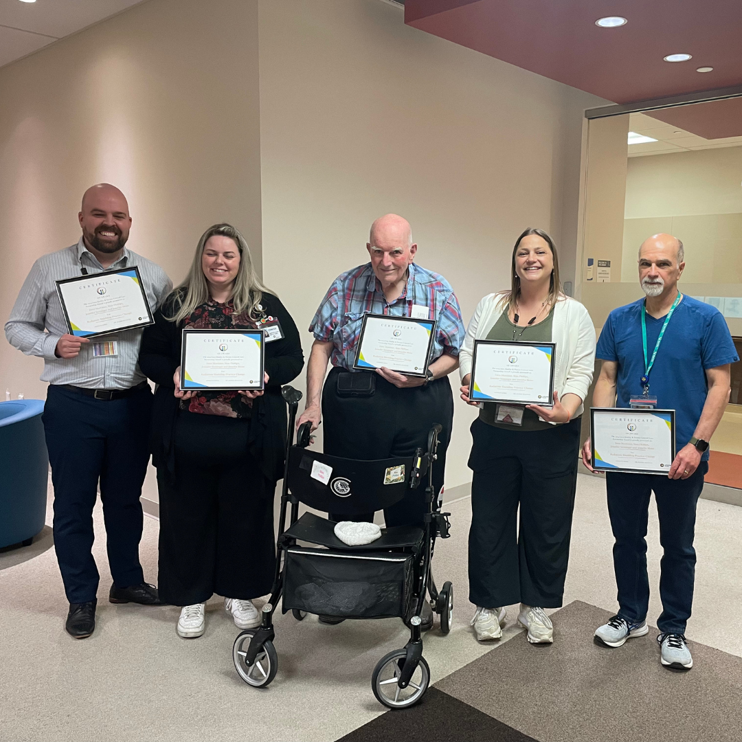 Group of people holding their certificates