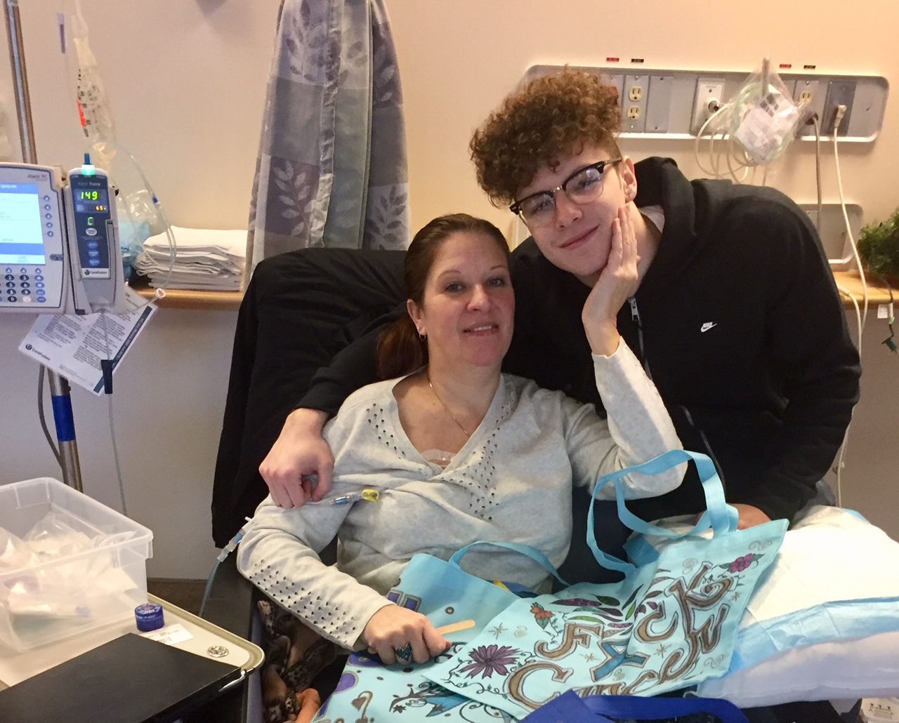 Tracy Dixon with her decorated cloth bags and her son