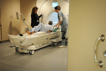 two technologists help a patient having an MRI