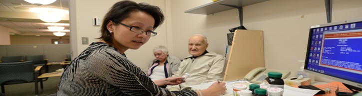 doctor talking to two patients in an office