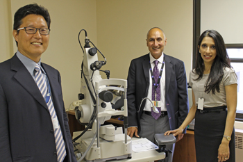 three surgeons with eye equipment