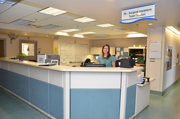 a nurse standing at a nursing station