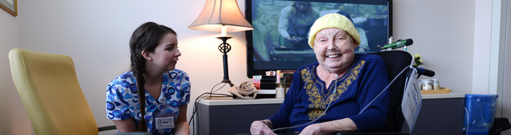 nurse talking to a patient in patient lounge