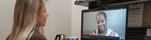 Staff member talking with a patient during video appointment.
