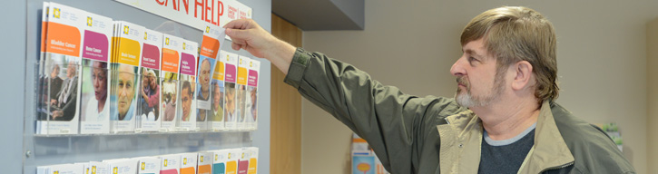 a man looking at brochures 