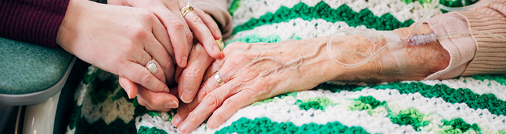 patient and family holding hands