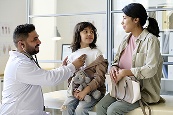 A pediatrician examines a patient