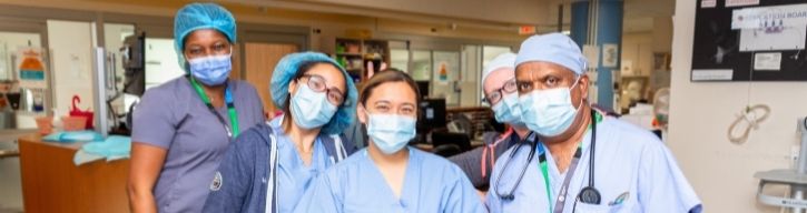 Heathcare team standing at nursing station.