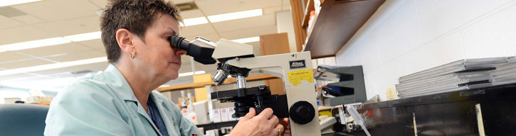 lab technician with a microscope